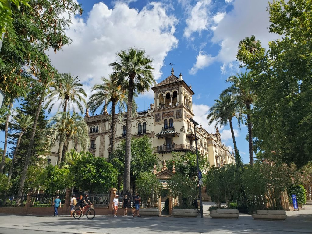 Sunny day in Seville with palm trees and historic Andalusian architecture near the city center