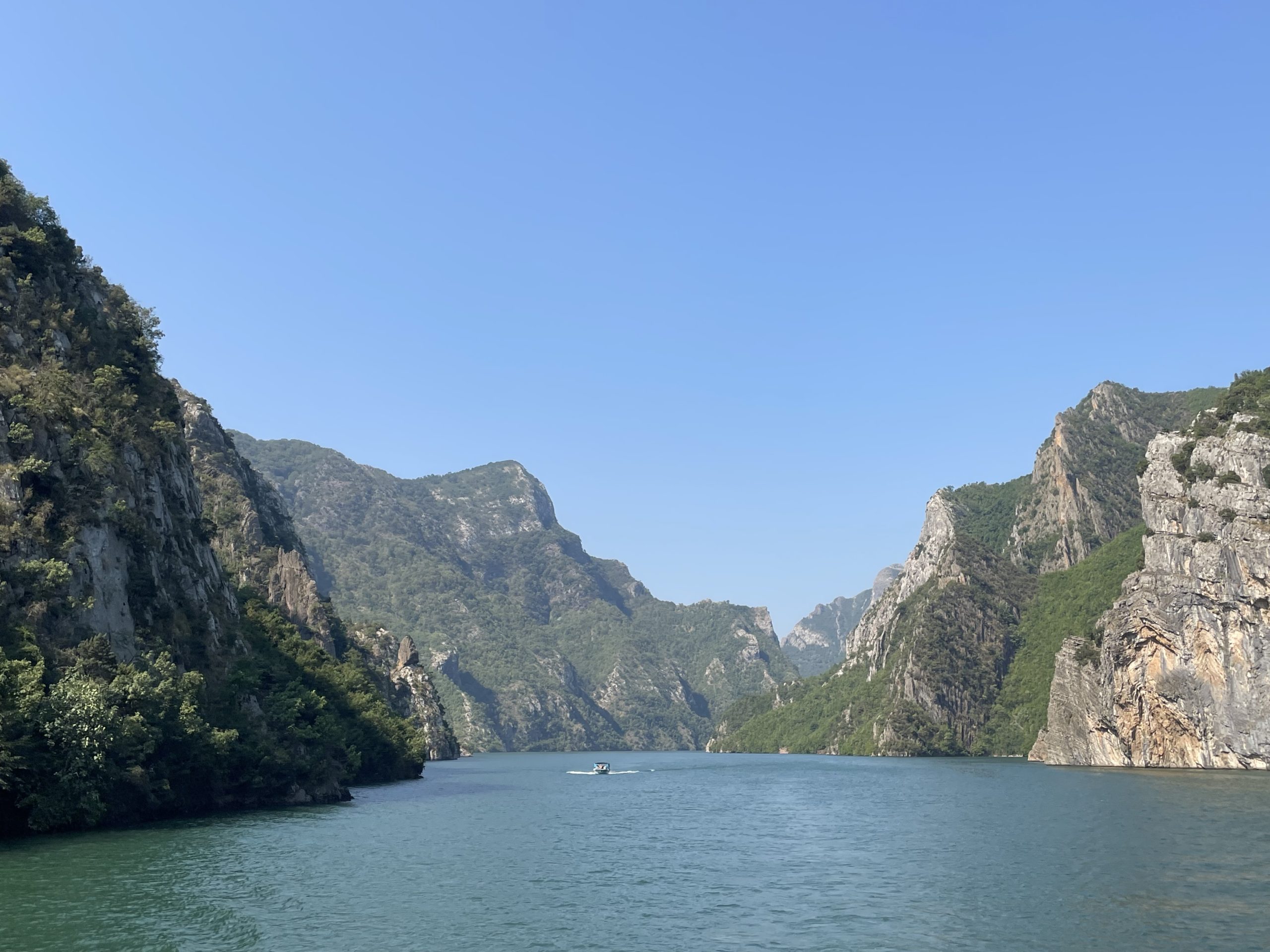 Scenic river canyon with towering cliffs and clear blue sky – nature travel destination