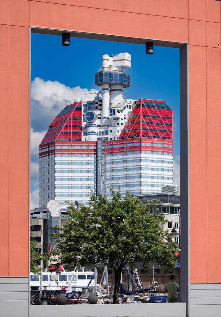 Lilla Bommen, Gothenburg’s red-and-white skyscraper, framed by modern orange architecture.