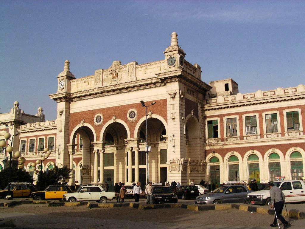 Exterior of Alexandria’s Misr Railway Station with colonial architecture and clock towers.