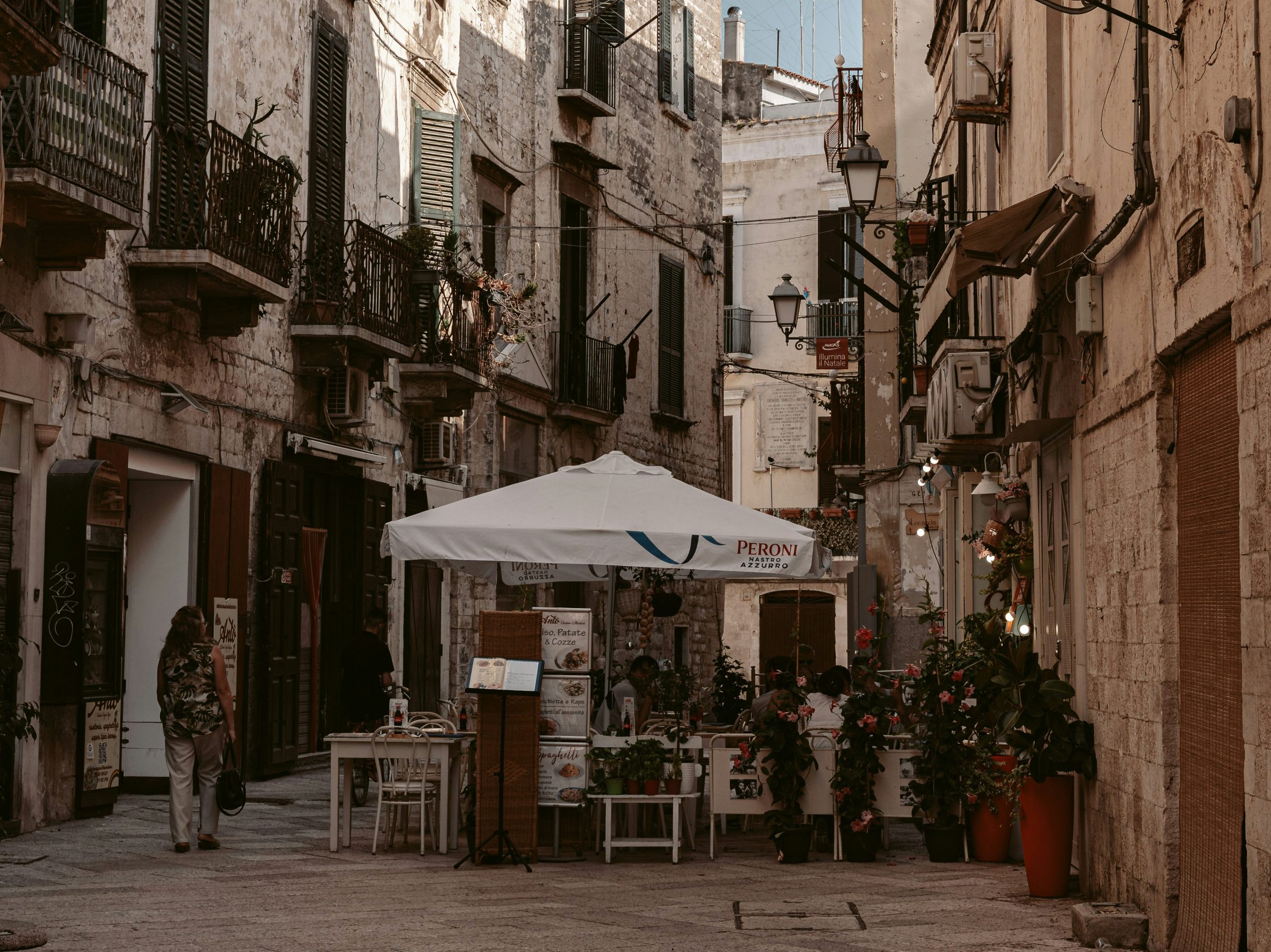 Narrow street in Bari Vecchia with outdoor restaurant seating