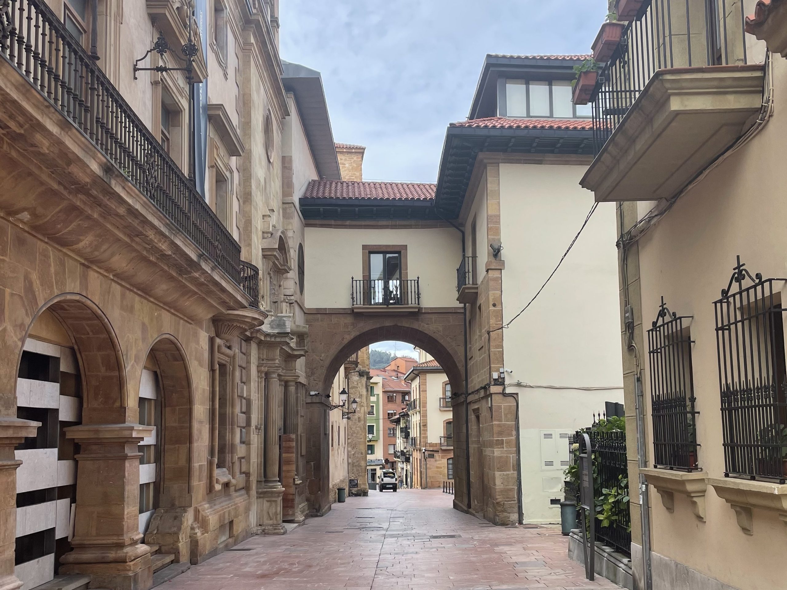 Stone archway and narrow street in the old town of Oviedo, Asturias, Spain.