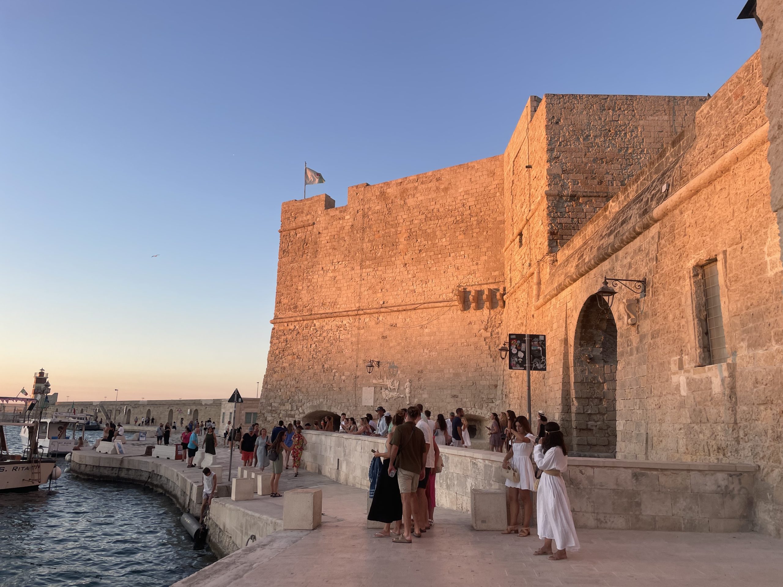 Sunset view of Monopoli’s old castle walls overlooking the Adriatic Sea