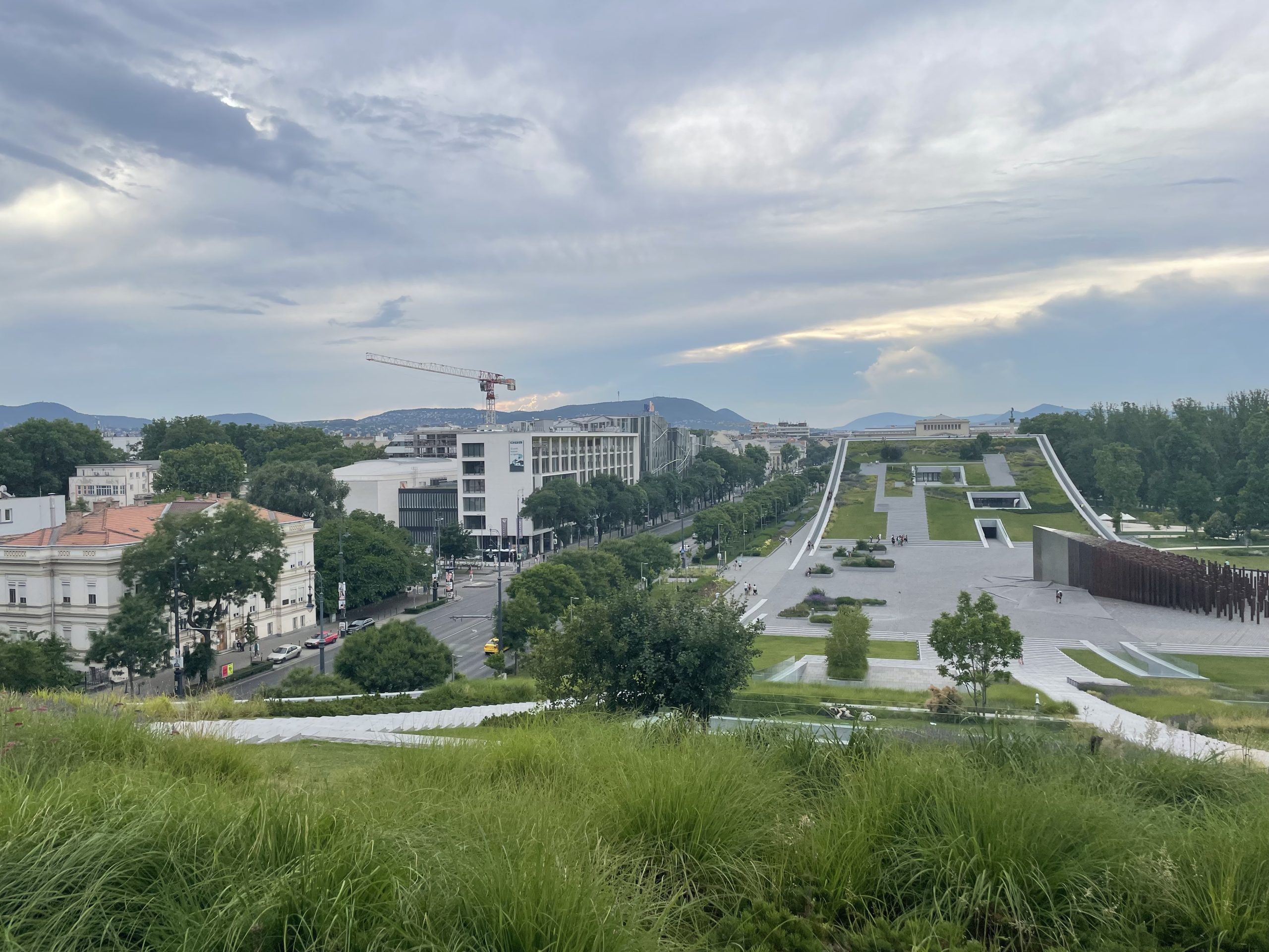 Modern memorial park in Budapest with wide green terraces and minimalist concrete structures