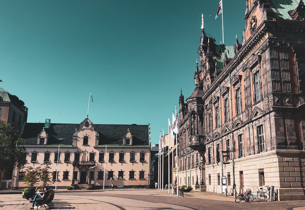 Beautiful historic buildings under a clear sky in Lund, Sweden, showcasing unique architecture.
