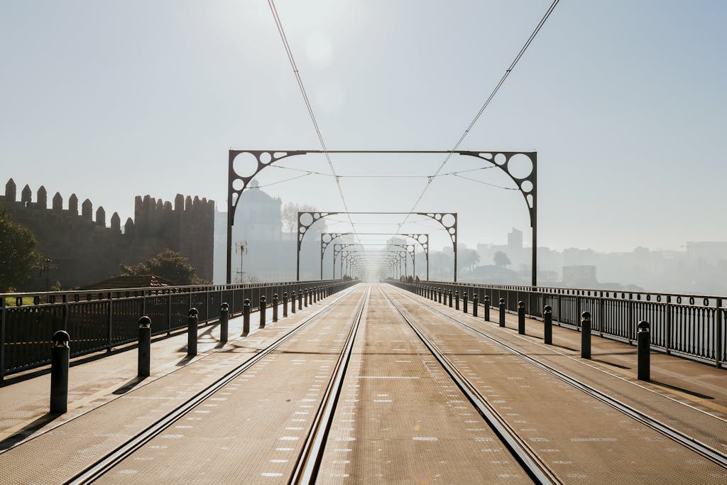 Explore the historic Dom Luís I Bridge in Porto, Portugal, shrouded in mist with a stunning urban perspective.