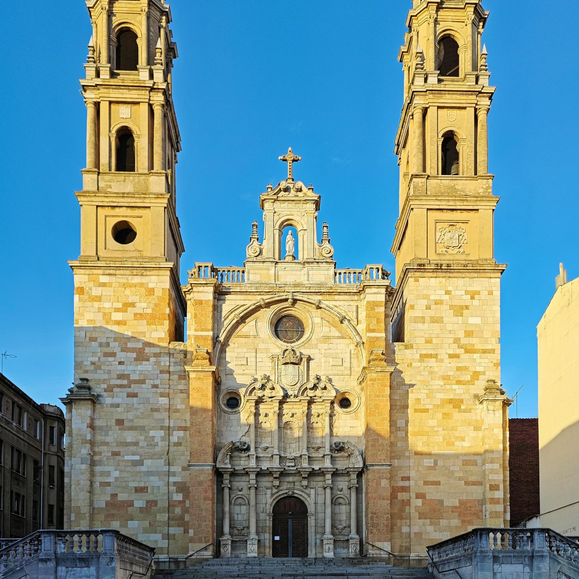 Front view of a Renaissance cathedral with twin towers in León, Spain, under clear sky.