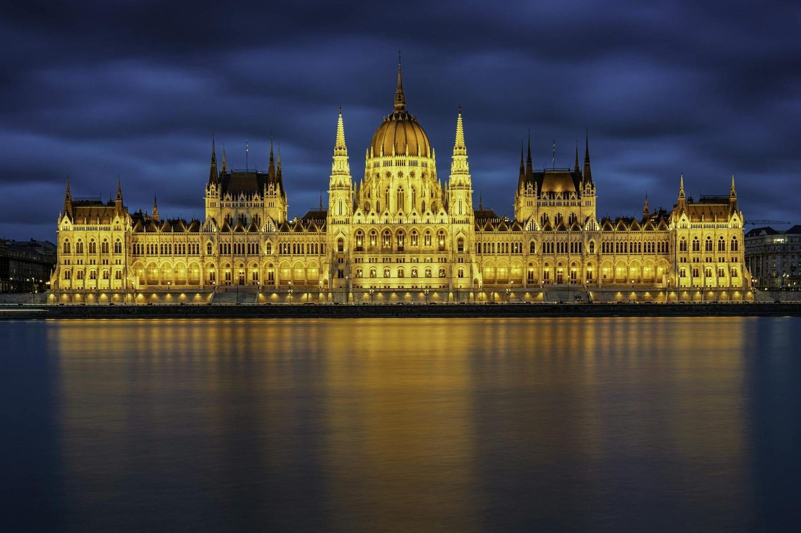 Stunning view of the Hungarian Parliament Building in Budapest glowing against the night sky in Budapest in June