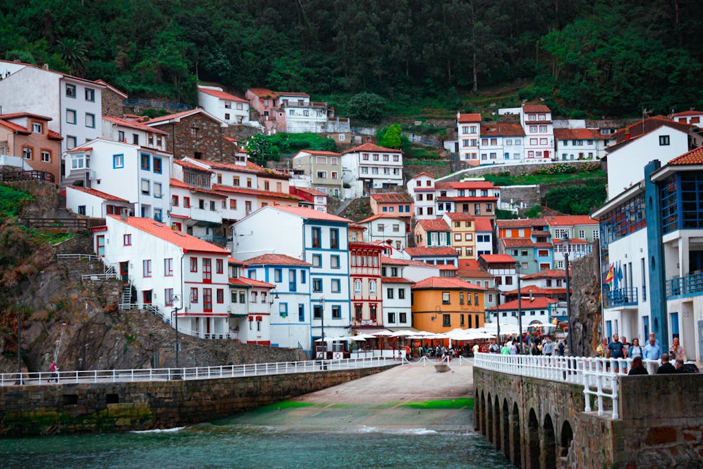 Vibrant houses nestled by the seashore in Cudillero, Spain, capturing charming urban architecture.