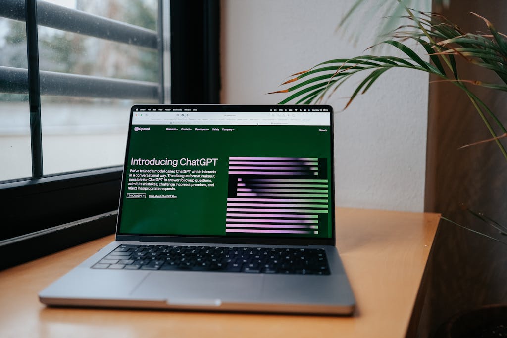 Laptop on a desk showing OpenAI’s ChatGPT introduction page, symbolizing starting the journey of learning coding with AI tools.