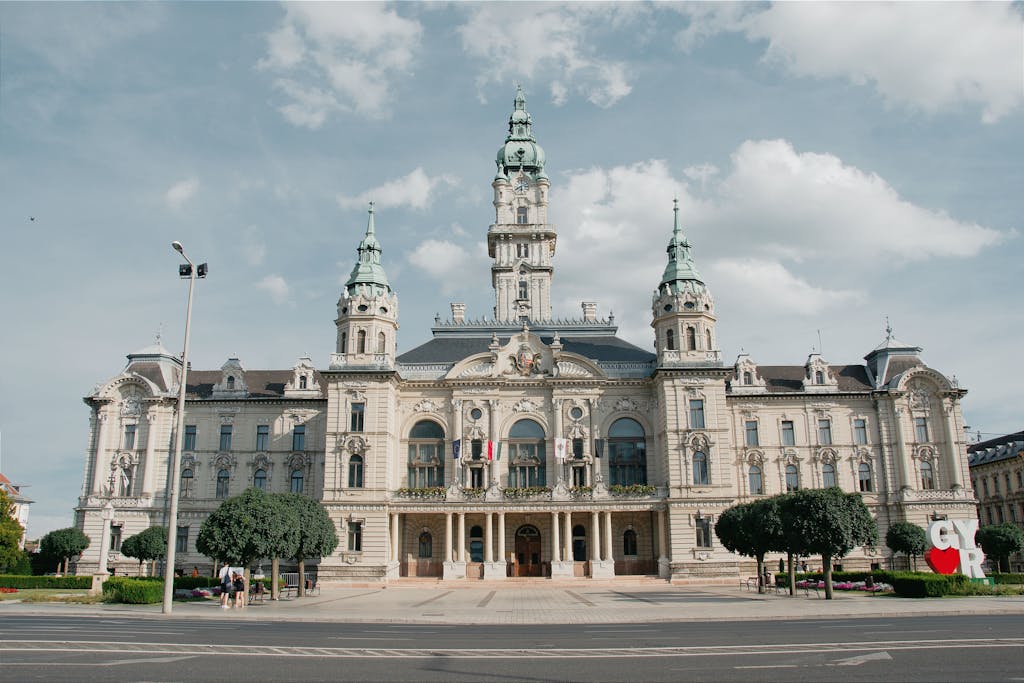 Győr City Hall, an elegant Baroque Revival–style building in Hungary, captured under a clear blue sky during a Vienna to Győr day trip.