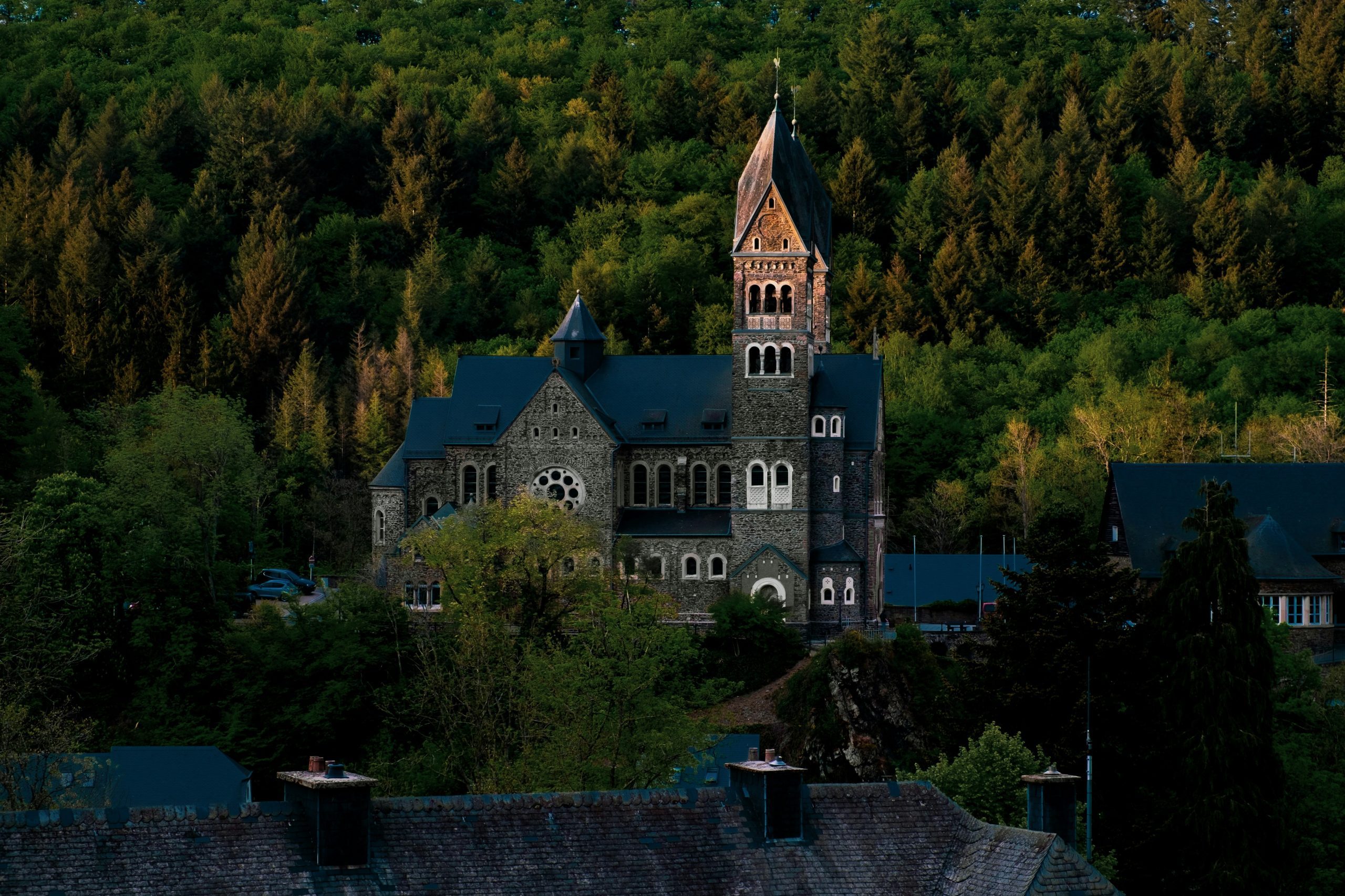 Clervaux Abbey in northern Luxembourg surrounded by forested hills