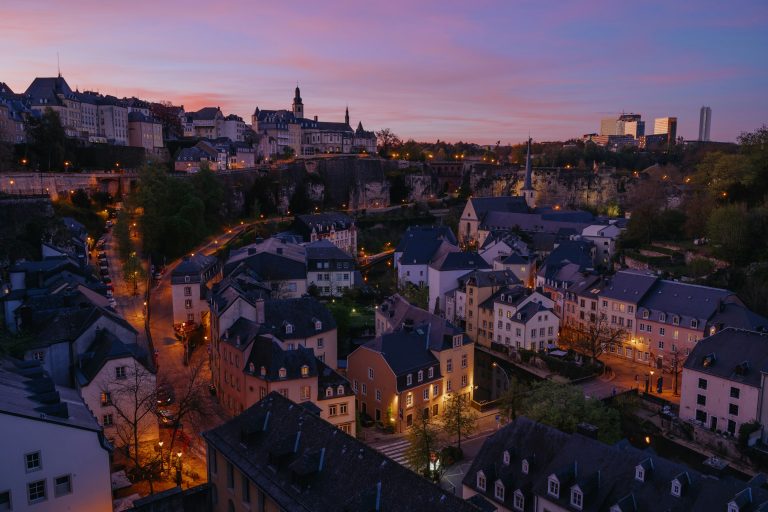 View of Luxembourg City and the Grund at sunset with historic cliffs and old town rooftops