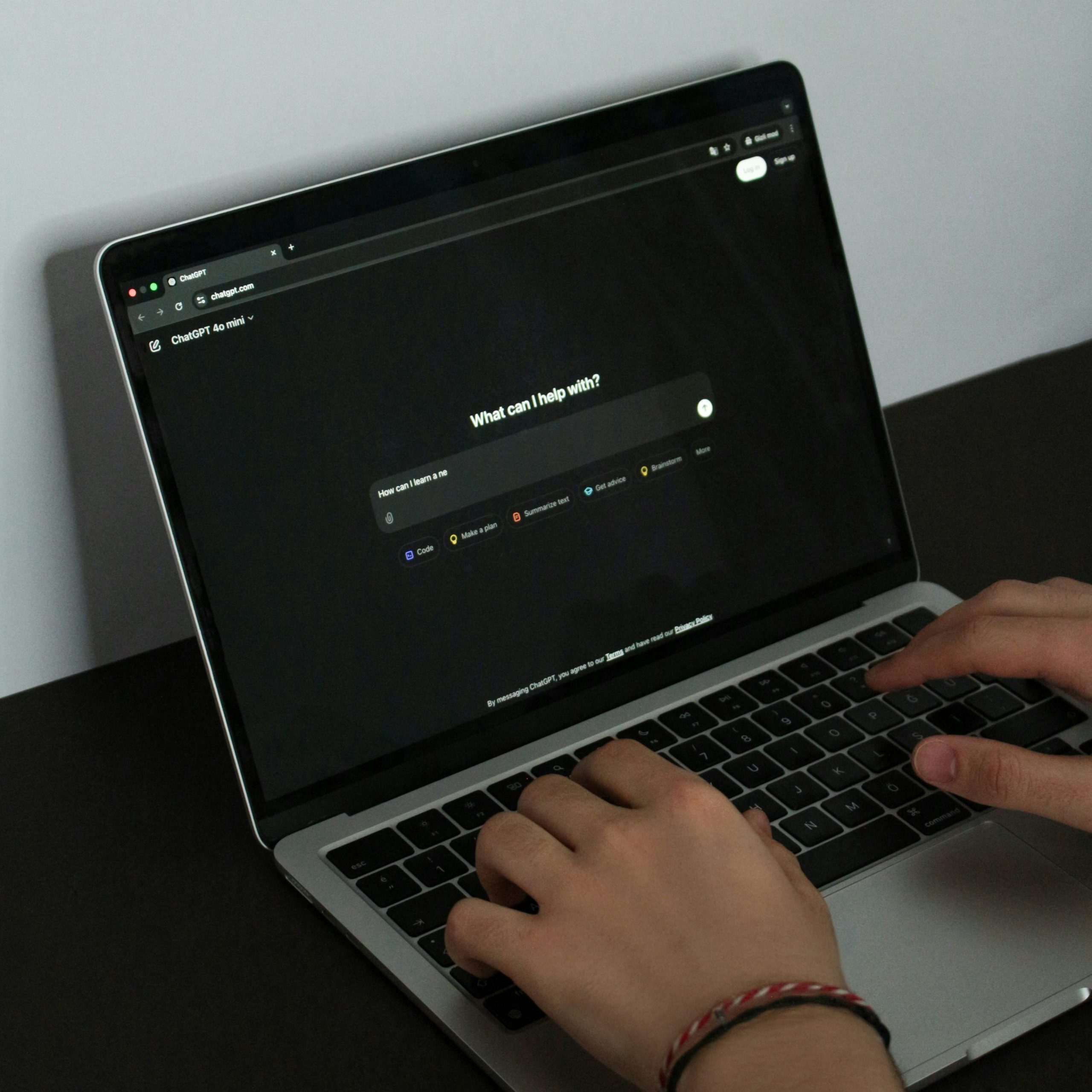 person typing a prompt into ChatGPT on a laptop screen, illustrating real-world use of AI prompting