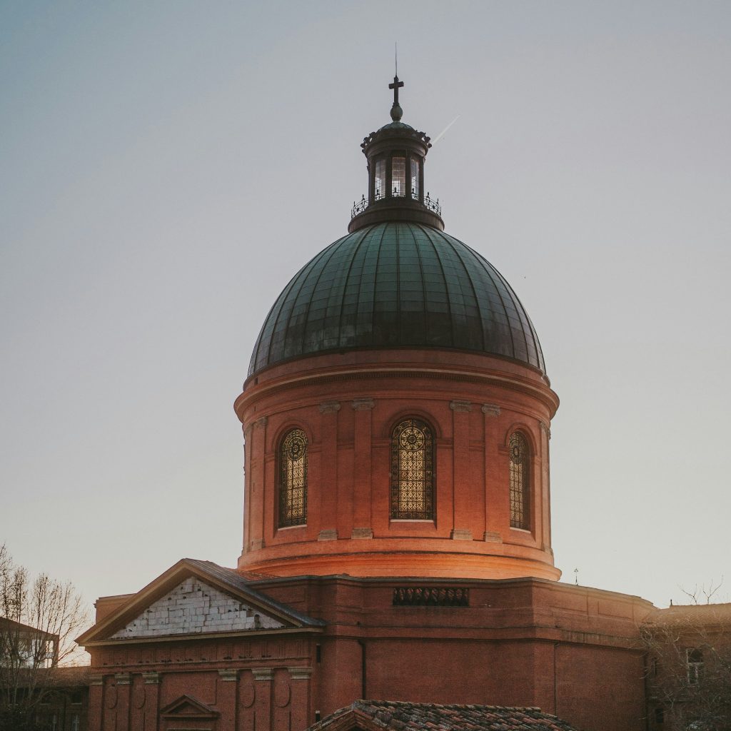 Dome de la Grave in Toulouse at sunset with warm light on the brick exterior