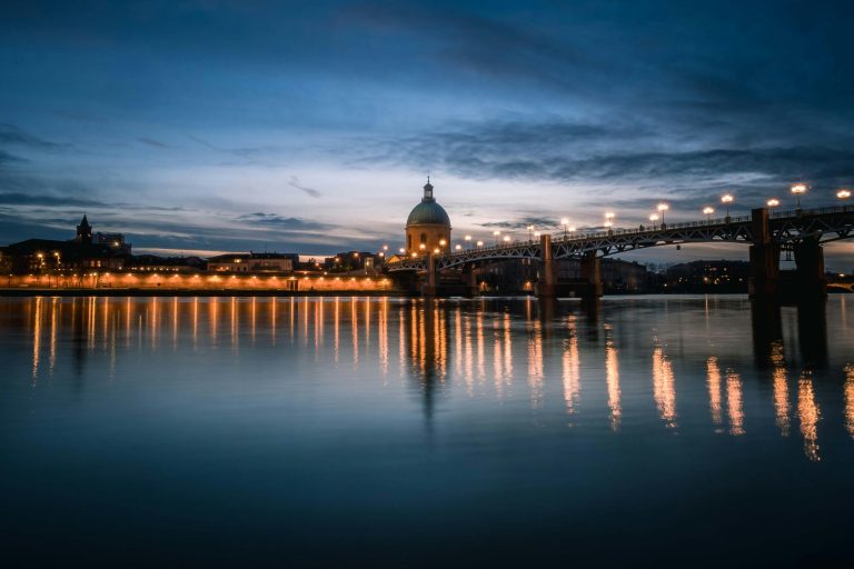 Garonne River at dusk with the Dome de la Grave and Pont Saint Pierre illuminated in Toulouse